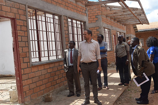 EU ambassador and other team members appreciating progress of a Library building under construction to support studies at MTC EU ambassador and other team members appreciating progress of a Library building under construction to support studies at MTC