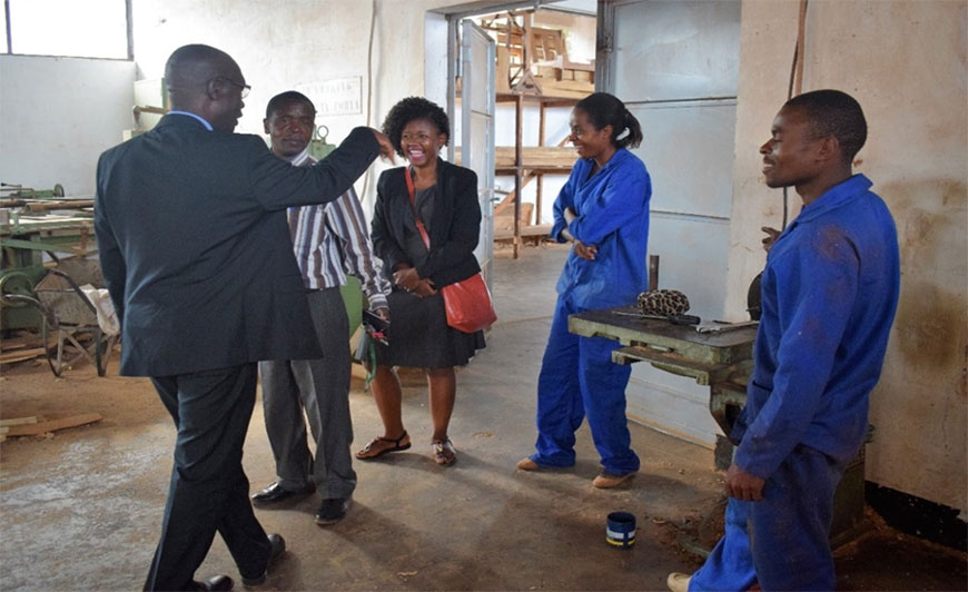 At Salima Technical College – NAO-SU Head of Operations, Charles Lumanga shares a joke with team members including NAO-SU Education Sector Manager Susan Komwa (C) and the College Principal (2nd L)